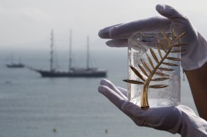 A Chopard representative displays the Palme d'Or, the highest prize awarded to competing films, in Cannes May 11, 2010. The Cannes film festival runs from May 12 to 23. REUTERS/Christian Hartmann (FRANCE - Tags: ENTERTAINMENT)